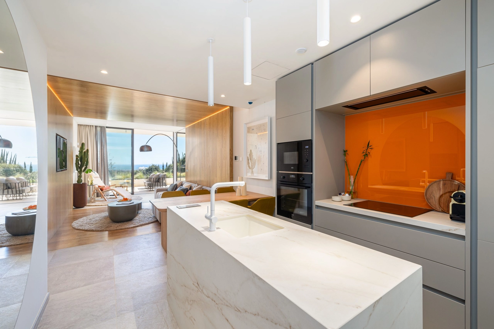 The modern Italian kitchen features a marble island and high-quality integrated appliances.