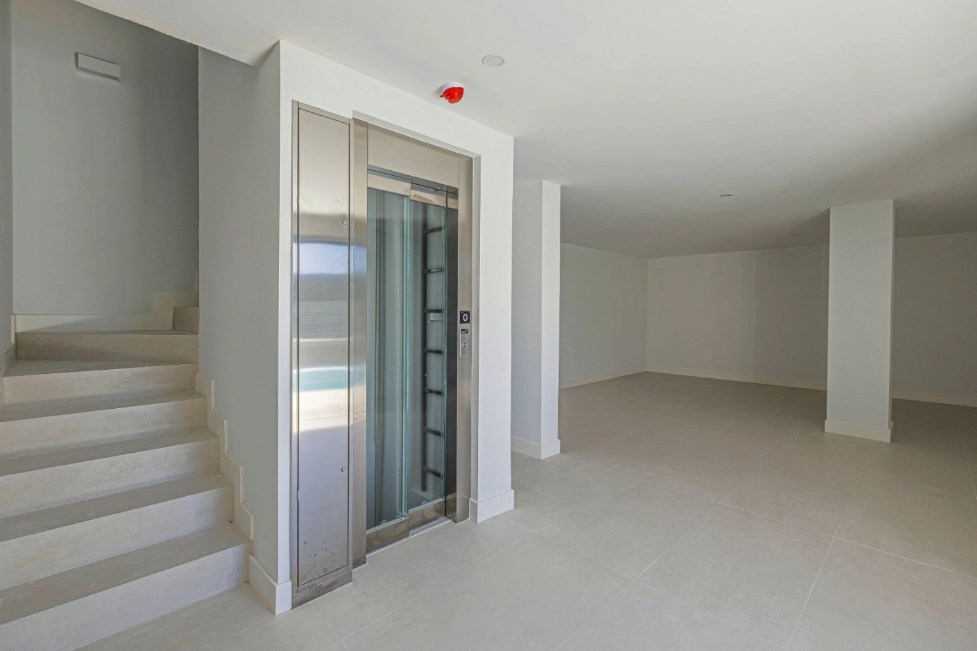 A modern glass lift provides convenient and stylish access to all levels of the villa.