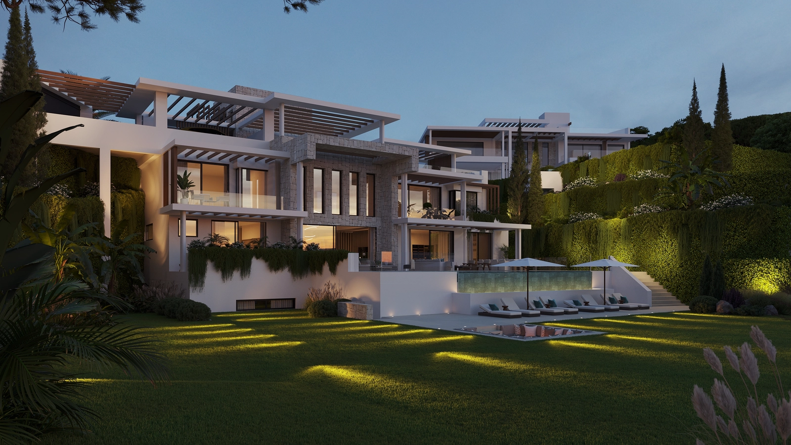As dusk falls, the villas are beautifully illuminated, creating a sophisticated and welcoming ambiance.