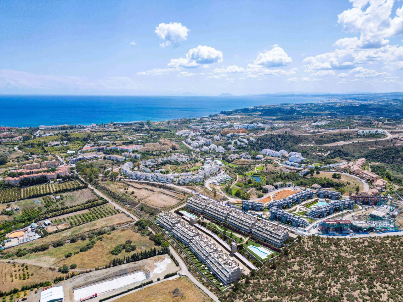 An aerial view showing the development's privileged position on the Costa del Sol, close to the sea.