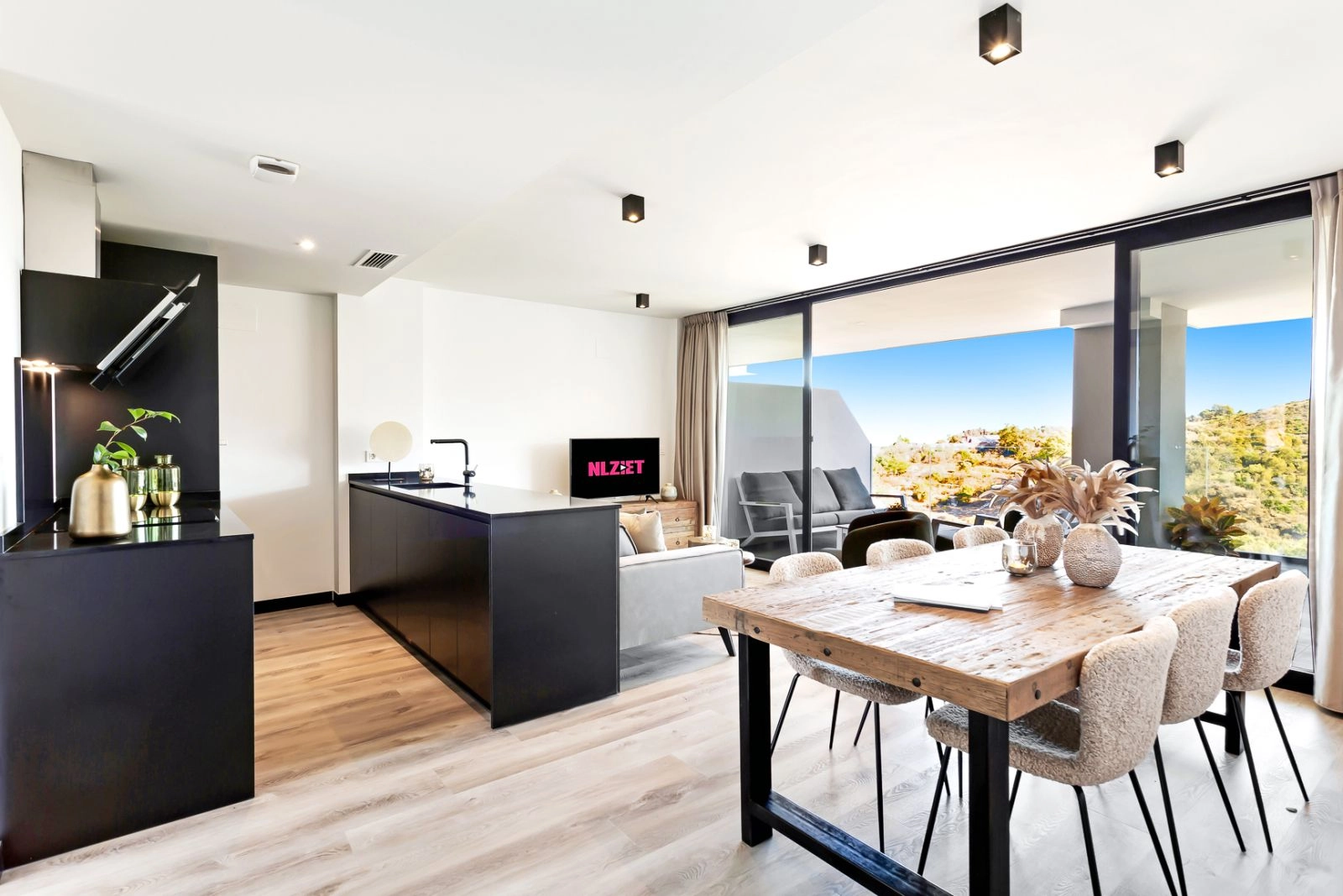 The kitchen and dining area are fully integrated, leading directly to the outdoor space for a complete indoor-outdoor lifestyle.