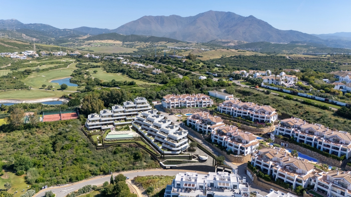 An aerial view showing the exclusive development nestled between the Casares golf course and the mountains.