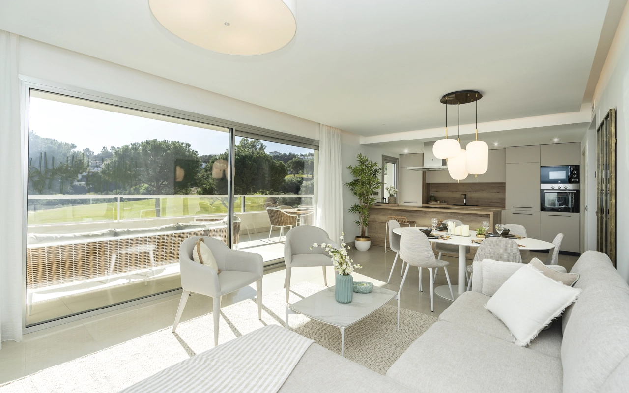 Sunlight fills the open-plan living and dining area, creating a bright and welcoming space for relaxation and entertaining.