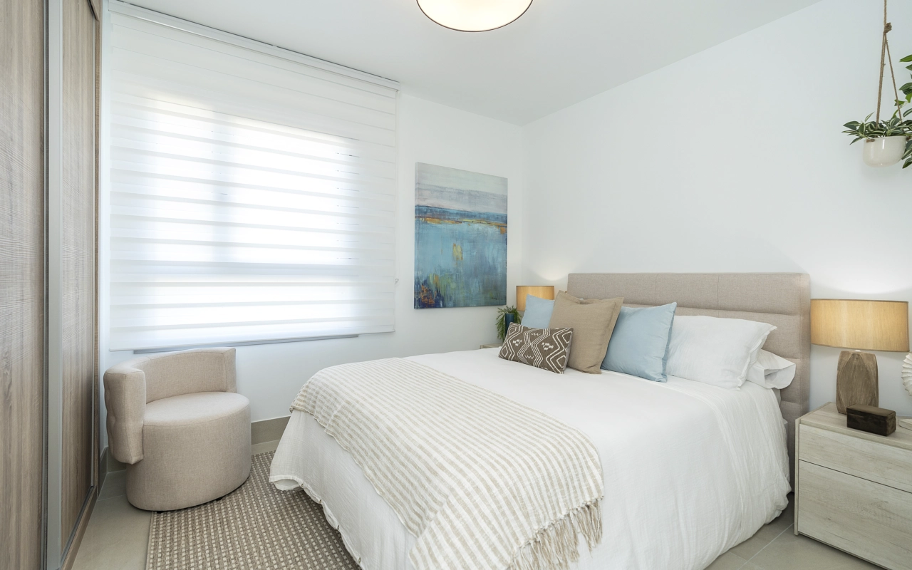 A serene and bright bedroom, designed as a peaceful space to rest and recharge.