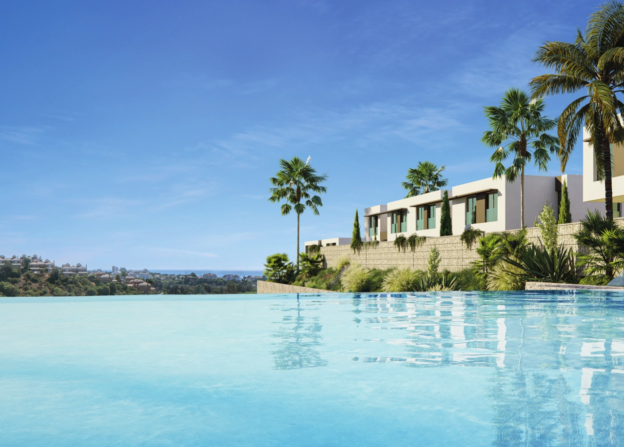 The communal infinity pool offers spectacular views over the landscape towards the sea.