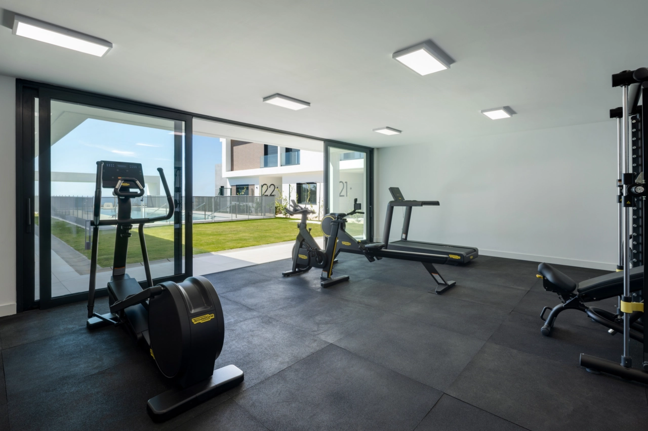 The residents' gym is fully equipped with modern fitness machines and offers inspiring garden views.