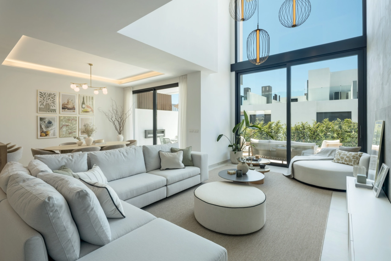 The double-height living area creates a sense of space and light, seamlessly connecting with the outdoors.