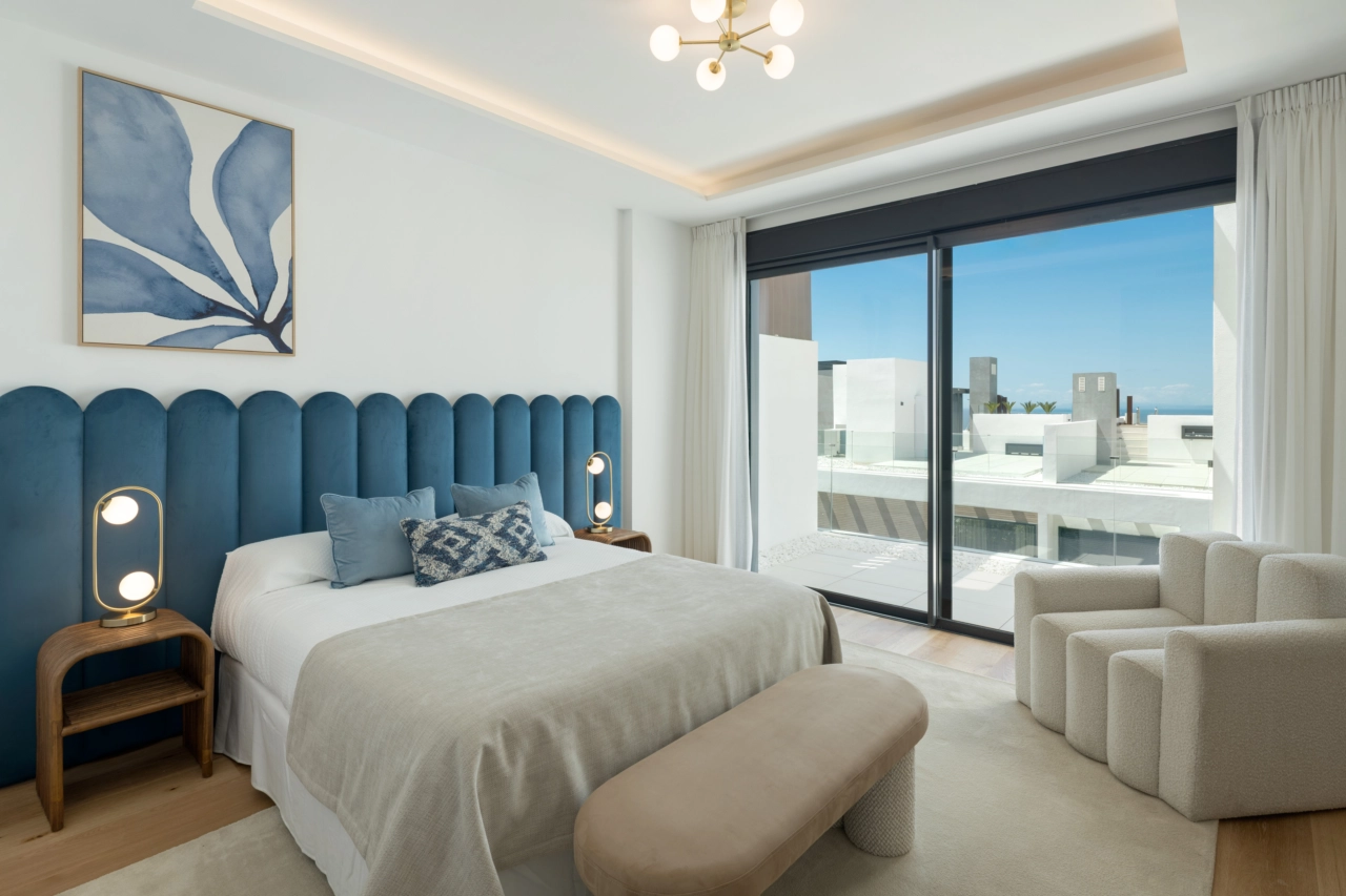 The master bedroom is a peaceful sanctuary with elegant design and large windows framing the views.