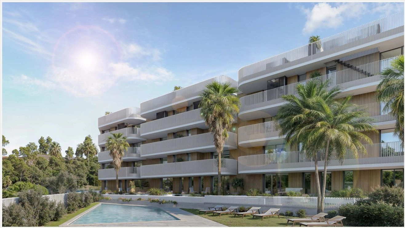 The development's modern architectural design harmonizes with the surrounding landscape and palm trees.
