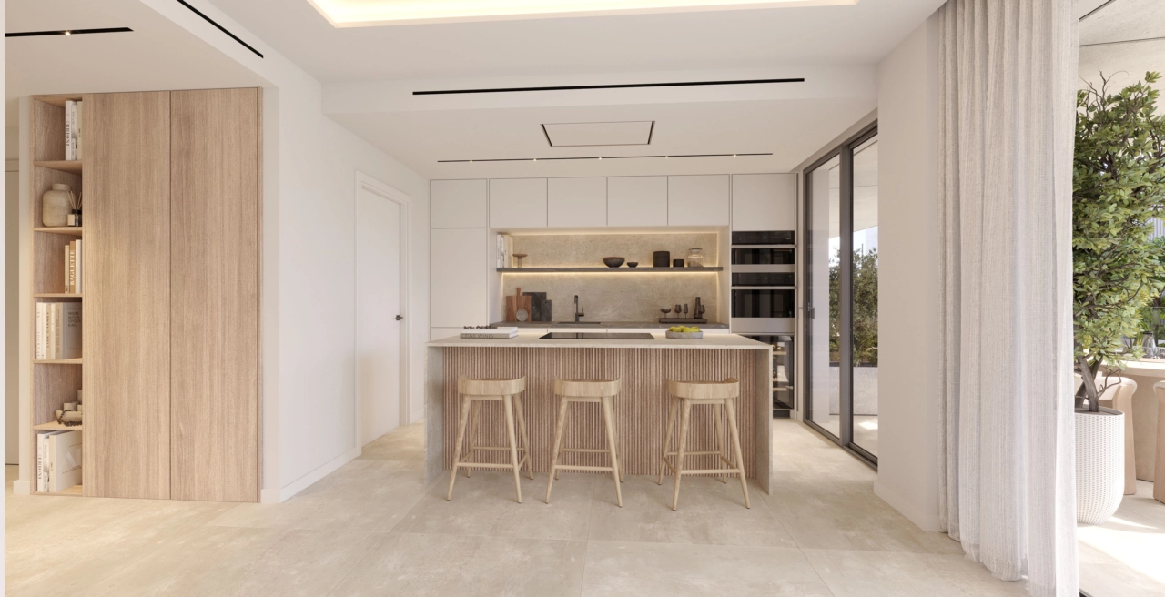 The modern, open-plan kitchen is designed with high-quality materials and features a breakfast bar for casual dining.