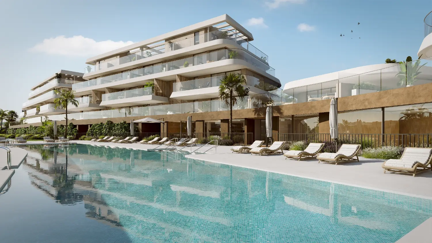 The elegant outdoor swimming pool, surrounded by relaxing sun decks and lush gardens.
