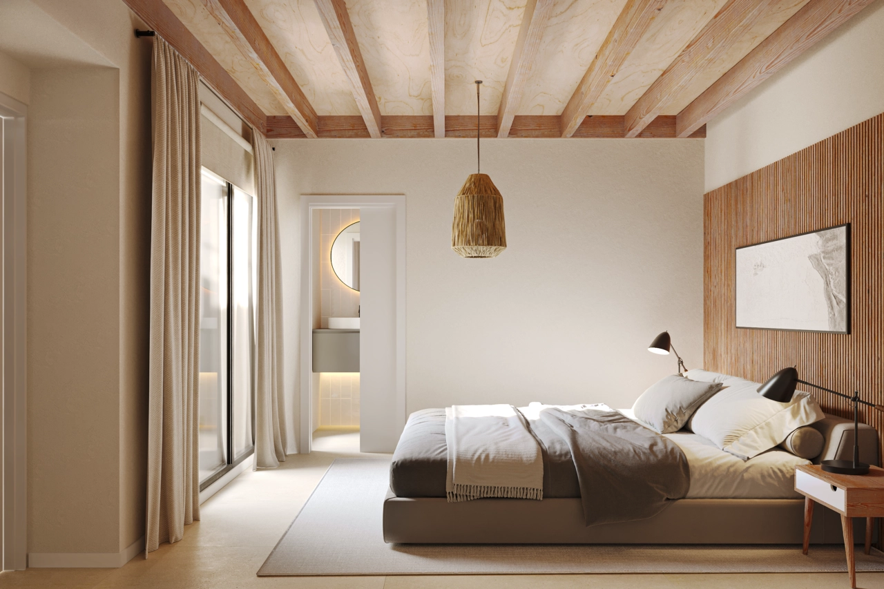 A serene bedroom with warm tones and direct access to a modern en-suite bathroom.