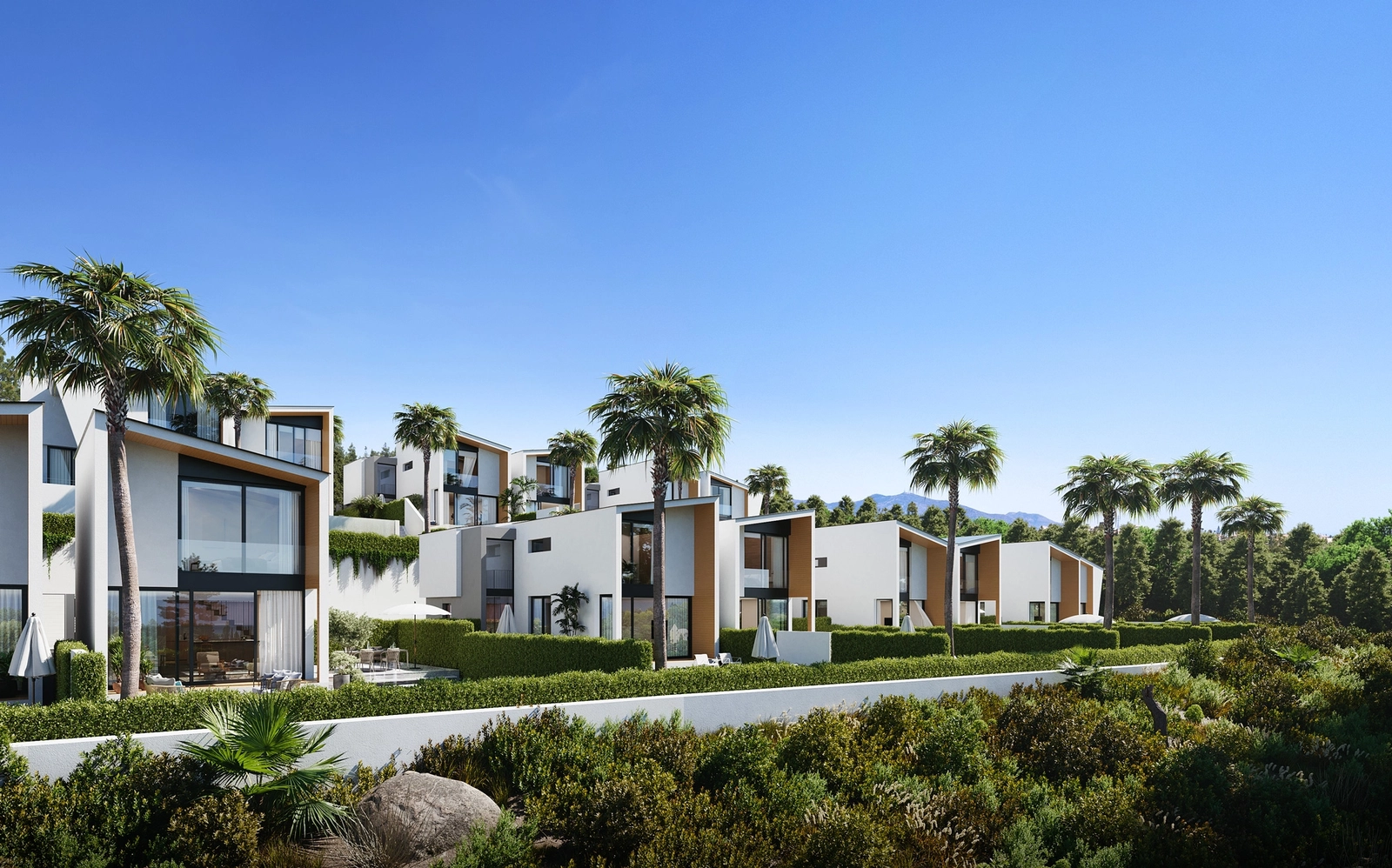 La impactante arquitectura moderna de los chalets destaca sobre el cielo azul claro y el exuberante entorno verde.