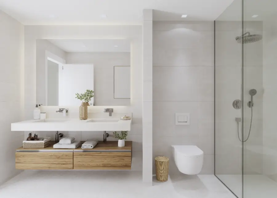 Un elegante baño principal con acabados de alta calidad, doble lavabo y una amplia ducha a ras de suelo.